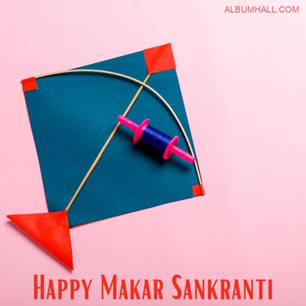 Sankrant blue, red kite & thread lying on a pink color table