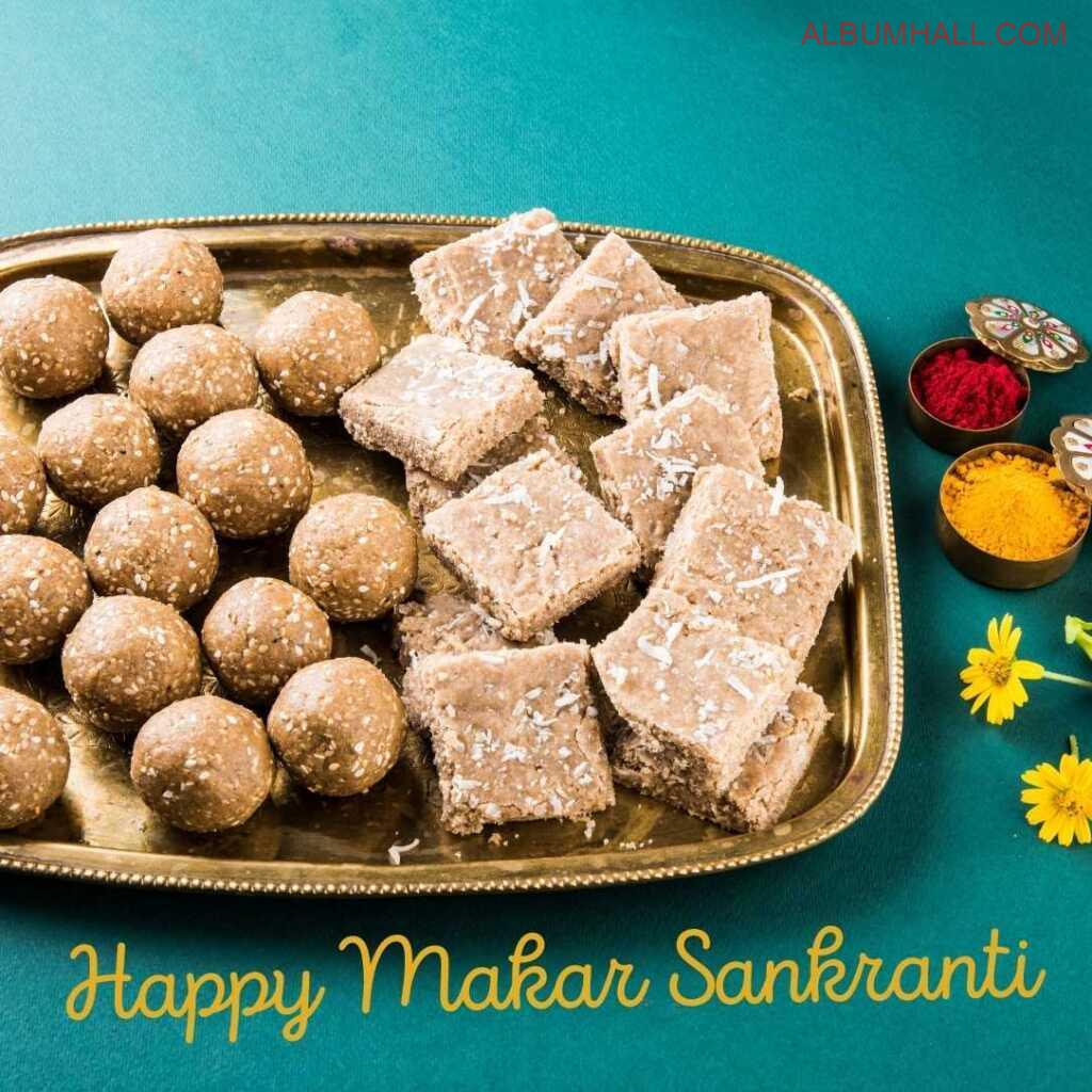 Sankrant special items like barfi, ladoo, flowers and colors on a decorated table