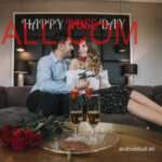 Couple sitting on dark grey Sofa with rose bouquet and Champaign glasses with strawberry on top celebrating Rose Day together