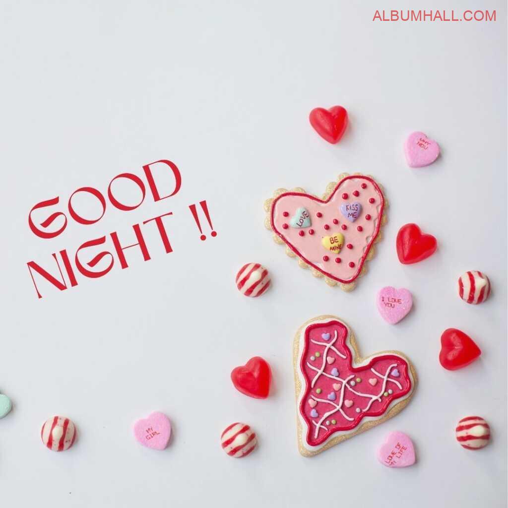 Red Heart shaped candies lying on a table saying good night
