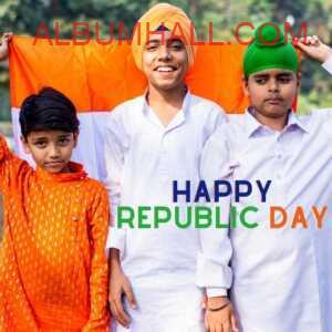 three children in saffron and white clothes holding India flag to celebrate republic day
