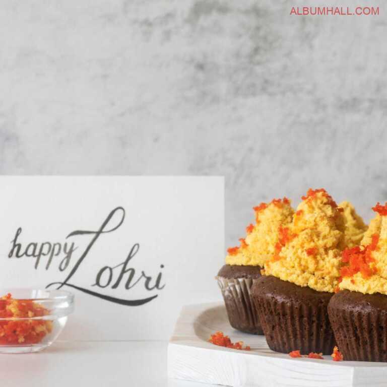 Happy Lohri note written on white paper with gajar halwa and three butterscotch & chocolate cupcakes