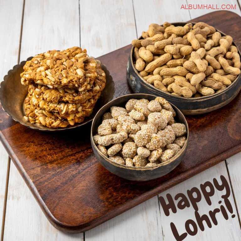 Different kind of Lohri sweets kept in three different bowls lying on a brown tray