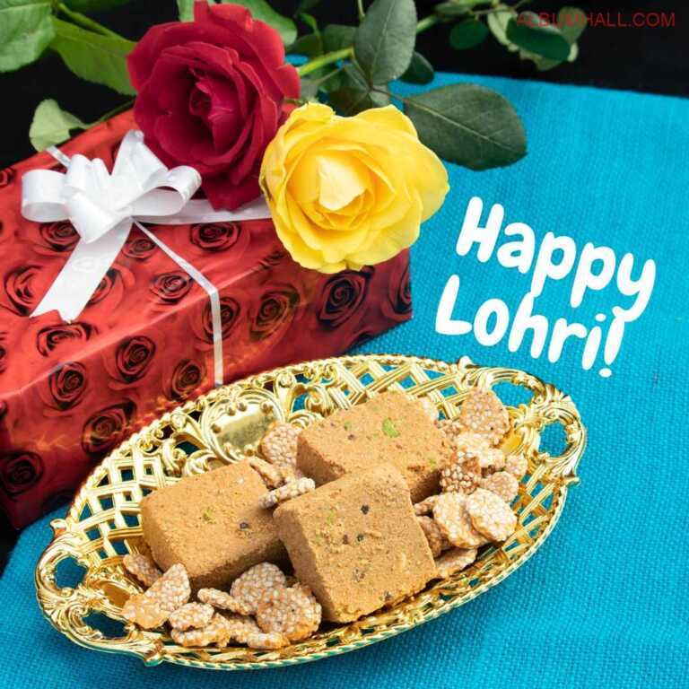 Lohri gift wrapped in gift wrap with red and yellow roses alongwith the seets kept in a oval gold color basket