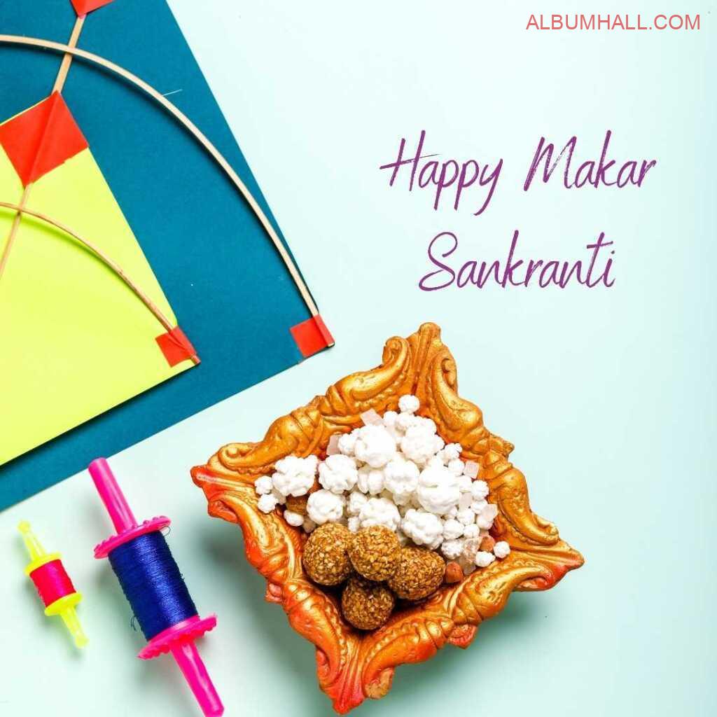 Sankrant sweets in diya bowl with kites and thread