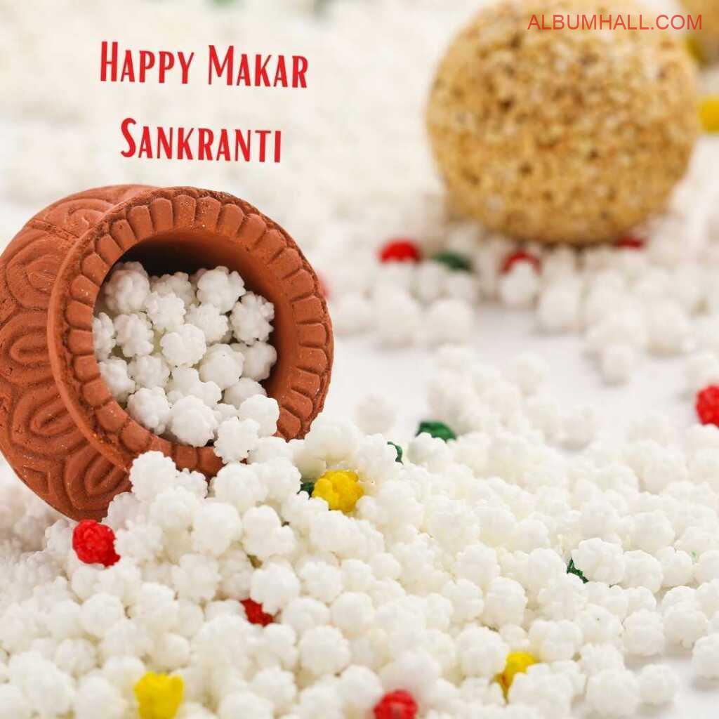 Sankrant sweets spilling out of brwon matka with one ladoo around