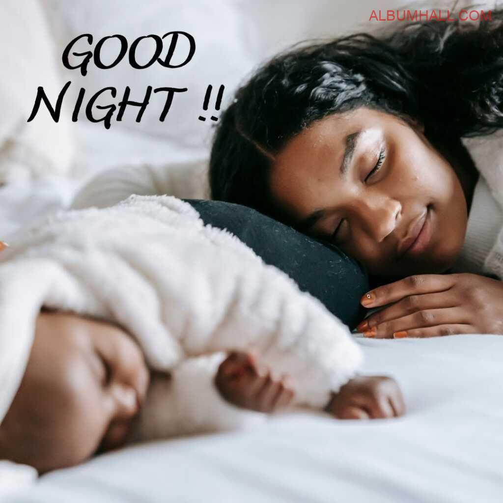 Women spending night with her infant kid around sleeping together in the night peacefully'