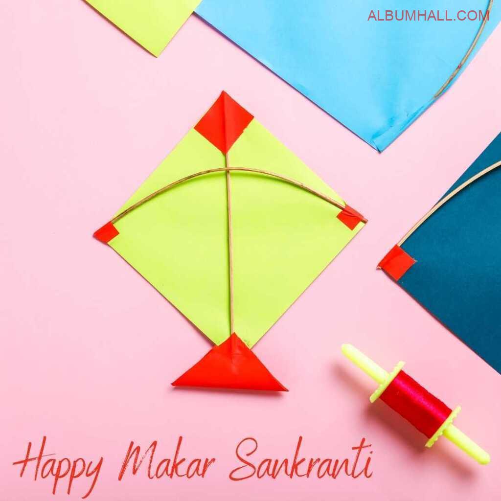 Yellow, red, blue Sankrant kites with red thread lying on table