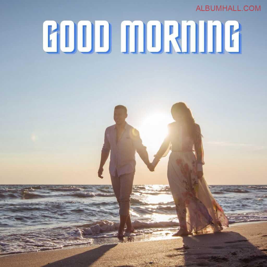 a couple holding hands and walking around beach enjoying the morning hours