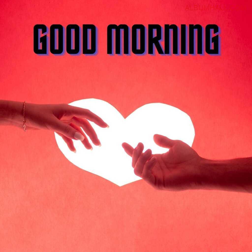 couple trying to hold each other hands around morning heart shaped sun which is in heart shape