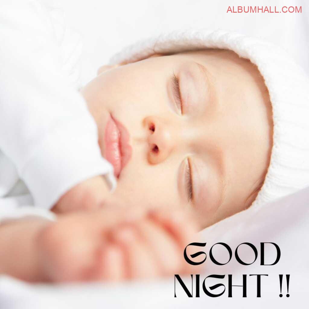 cute baby with pink lips sleeping and wishing good night in her white color woollen cap and dress