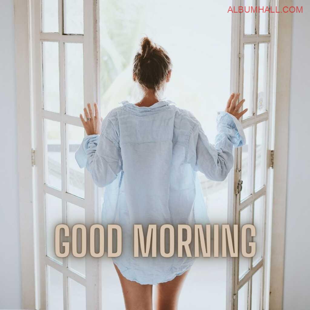 girl wearing shirt enjoying morning view through the window