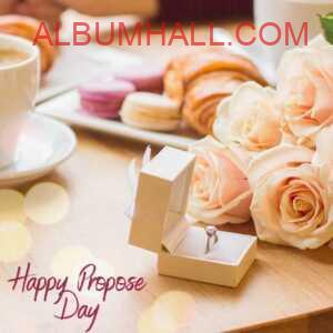 cream color roses with ring in a box on coffee table to wish happy propose day