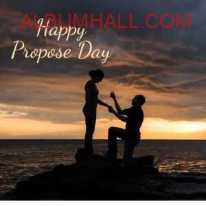 happy propose day my love - boy proposing to his girl kneeling down with ring on sea shore