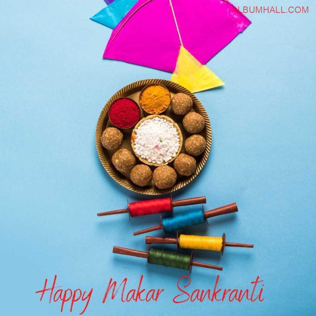 Makar sankrant wishes with colored four threads, ladoos in plate and kite lying in vertical