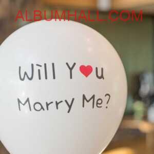 white balloon with note "will you marry me?" on propose day