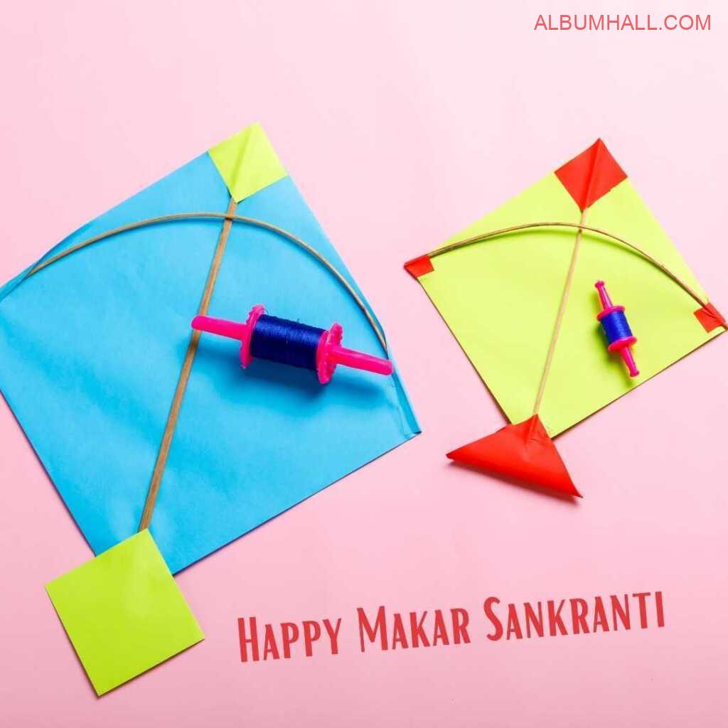 two Sankrant kites colored blue & yellow with threads lying on the table
